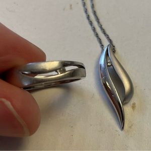 Silver and diamond ring and pendant set